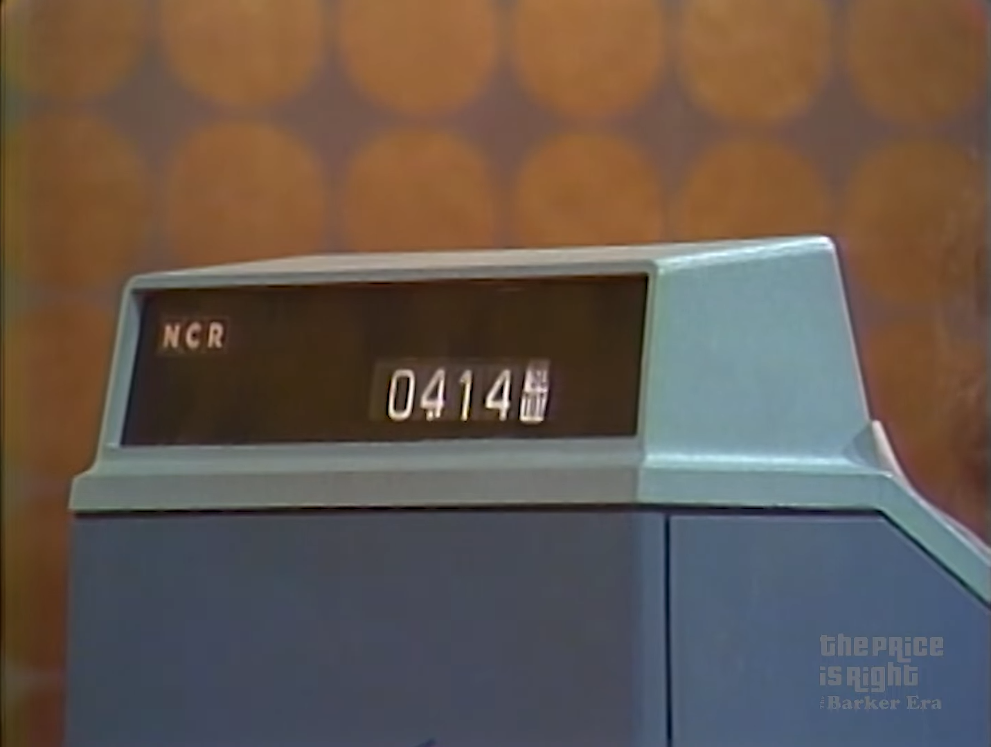 Close-up of an old-school cash register displaying the total amount of .14.