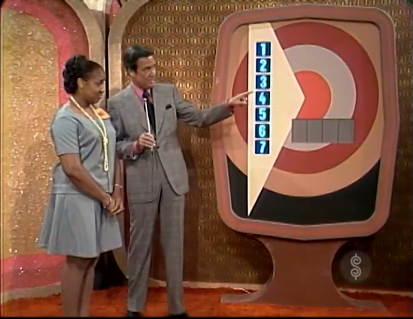 A contestant stands next to the Bullseye game board on The Price is Right in 1972.