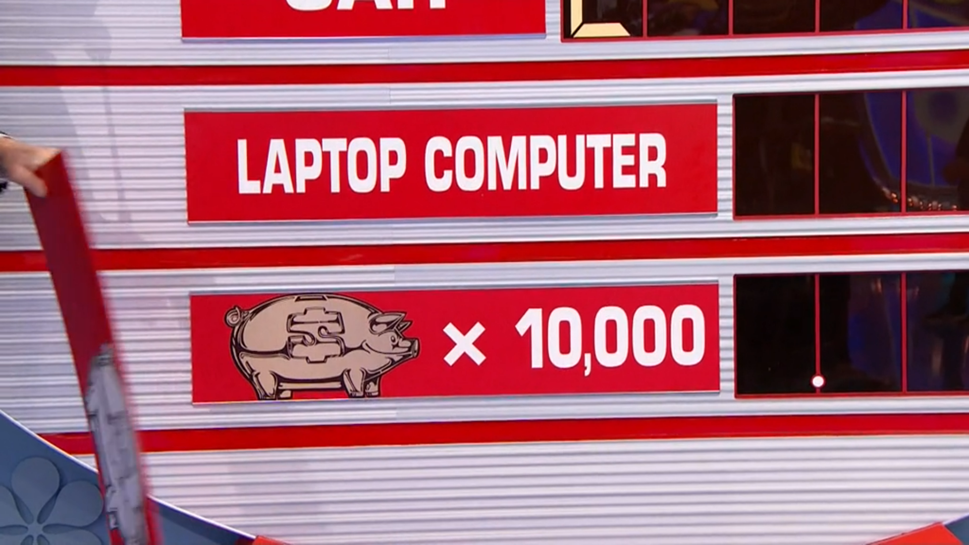 An Any Number game board on the Price is Right showing prizes, including a car, a laptop computer, and a piggy bank multiplied by a value of 10,000.
