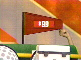 What's different here? The price is being shown while the flag is still on the prize display. At one point a prize was picked, then revealed, and the flag was set on the putting green. The player picked again if the price was higher than the previous choice.