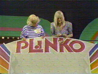 A contestant invites Dian to drop a Plinko chip off the top of the Plinko board to help reverse a losing streak.