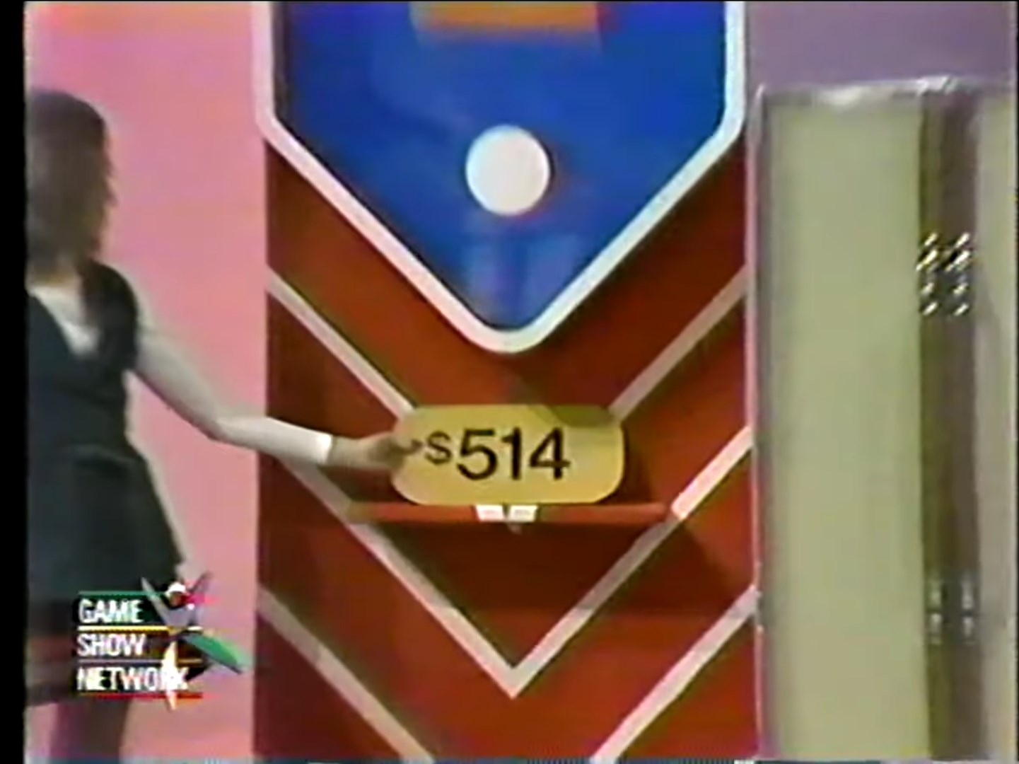 A contestant points to a price tag showing 4 in a game show setting.