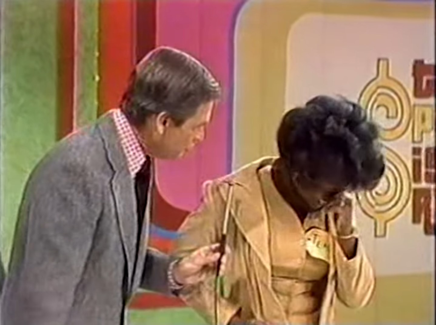 A host interacts with a female contestant who appears emotional during the 'Five Price Tags' game on The Price is Right.