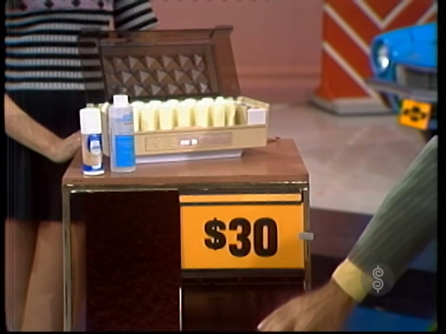 A display showing a hair setter and two bottles of product, with a price tag of .