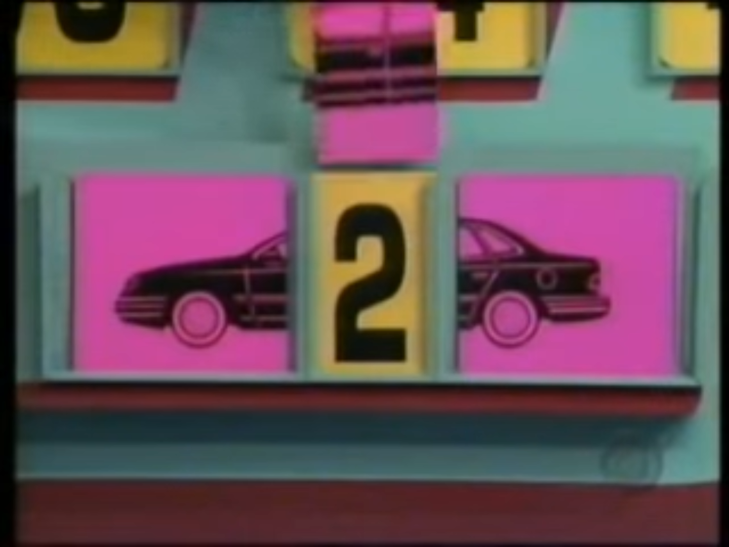 A display board for a car game featuring the number 2 alongside images of a car, set against a colorful background.