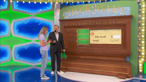 Drew Carey and a contestant engage with a game board in the 'Check Game' segment of The Price is Right, featuring a colorful backdrop.
