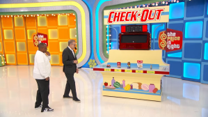 Drew Carey hosting the Check Out game with a contestant on the set of The Price is Right.