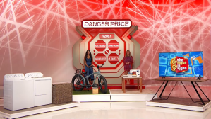 Set from the game 'Danger Price' on The Price is Right, featuring a bicycle, a television, and a washer on a decorative stage with bright red background.