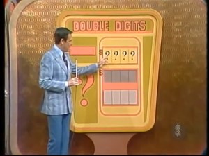 Bob Barker presenting the 'Double Digits' pricing game on The Price is Right, with a large colorful game board featuring question marks and number slots.
