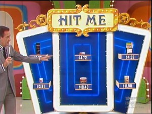 Bob Barker presents the pricing game 'Hit Me' on The Price is Right, with various product prices displayed on a colorful Blackjack game board.