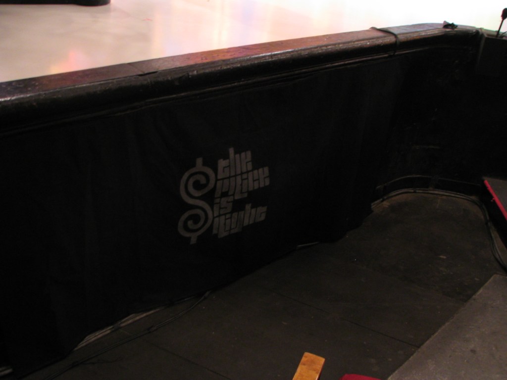 A black curtain with the text 'The Price is Right' printed on it, positioned near a stage edge.