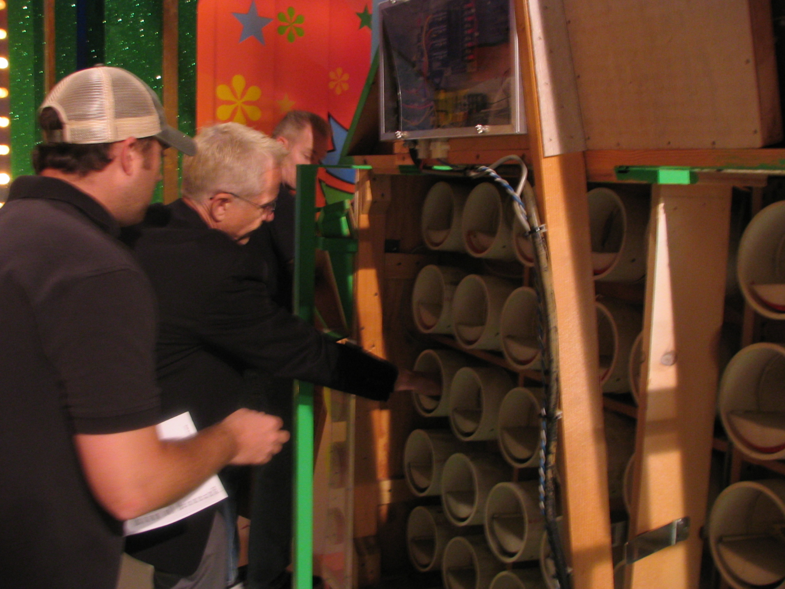 Behind-the-scenes shot of the Punch a Bunch game with production staff interacting with the punchboard setup.