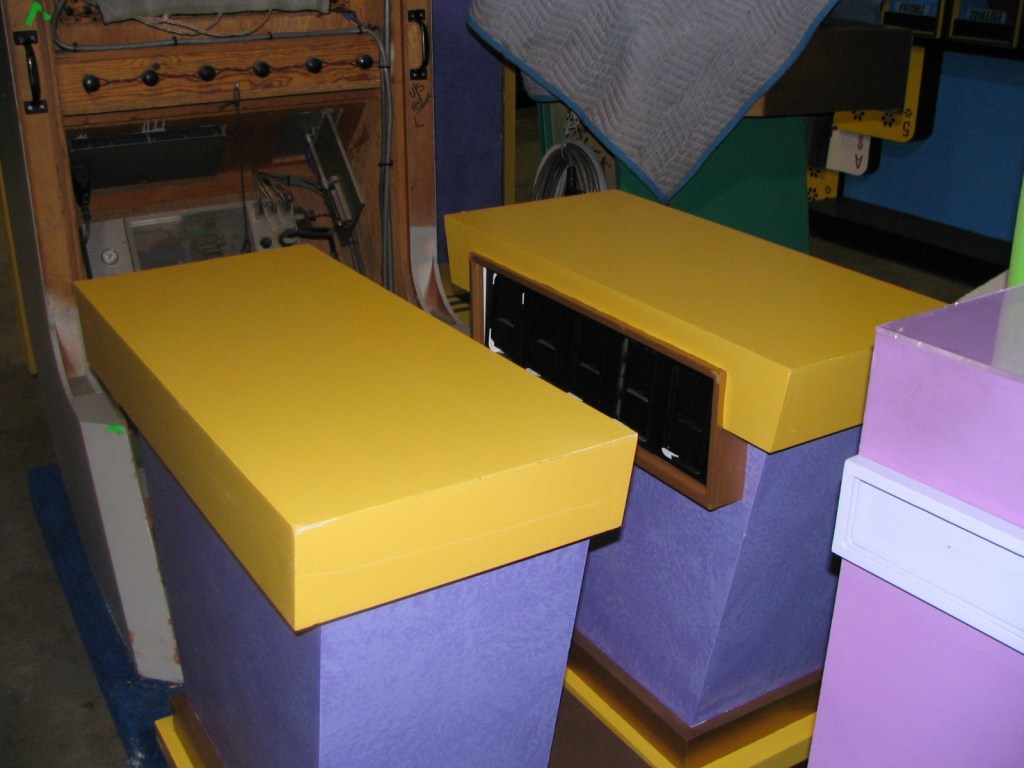 Backstage setup featuring purple and yellow surfaces, possibly part of a stage or set design.