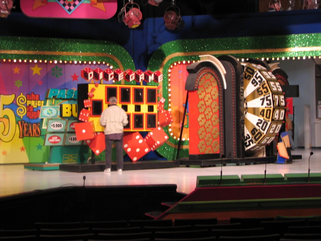 Backstage setup for the 35th season of The Price Is Right, featuring colorful game displays and a large spinning wheel.