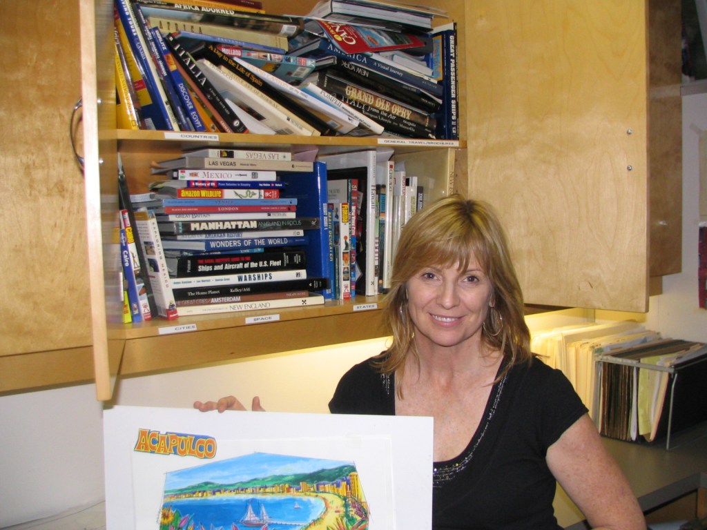 A woman smiling while holding a colorful poster of Acapulco in front of a bookshelf filled with various travel books.