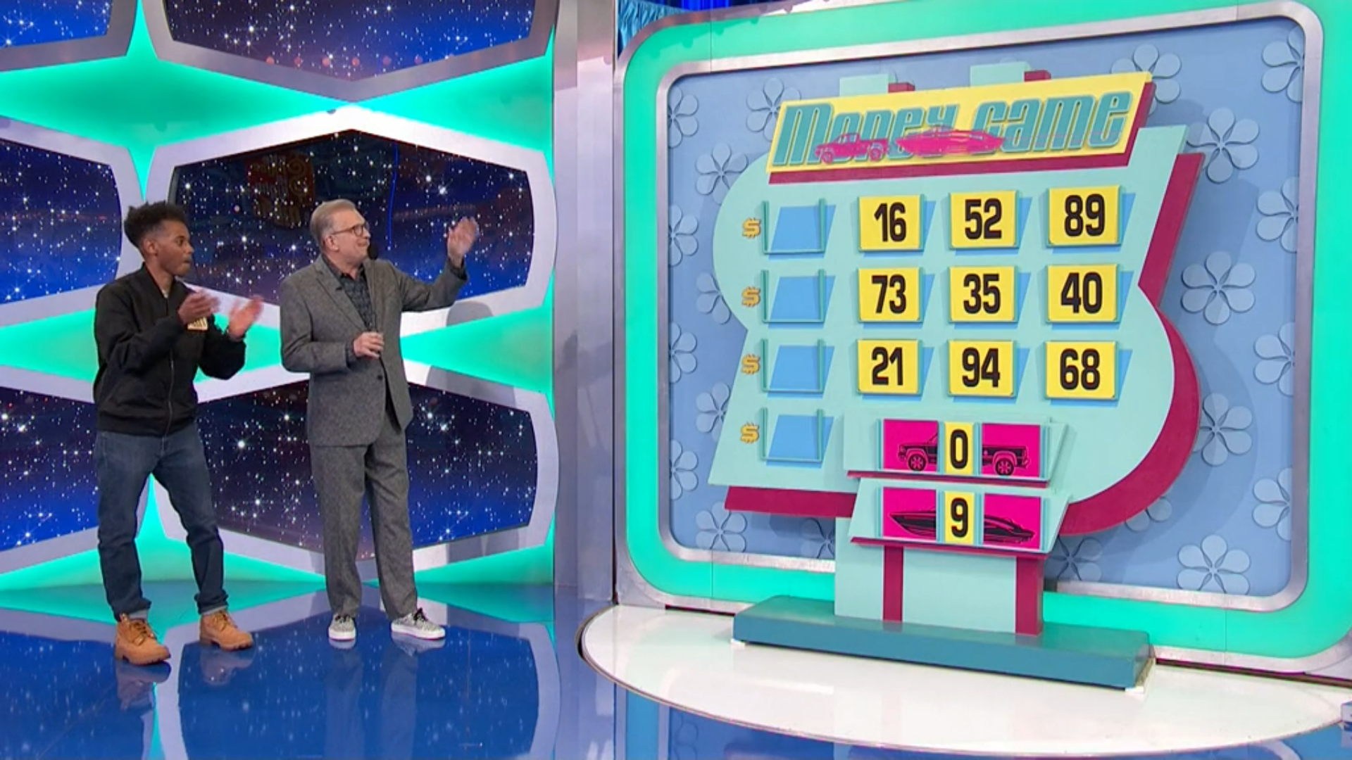 A contestant and a host stand in front of the 'Money Game' board on a game show, featuring numbered slots with dollar signs and two icons representing a car and a boat in a special primetime twist.