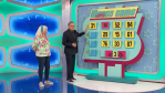 A contestant stands beside the 'Money Game' board on The Price is Right, featuring numbers and colorful graphics, while the host interacts with them.