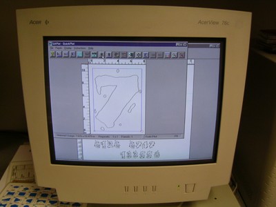 Old computer monitor displaying a software interface with a design featuring the number 7 and technical measurements.