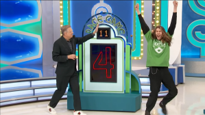 A contestant on The Price is Right is celebrating with arms raised next to the host, who is pointing at the 'Race Game' display showing the number 4.