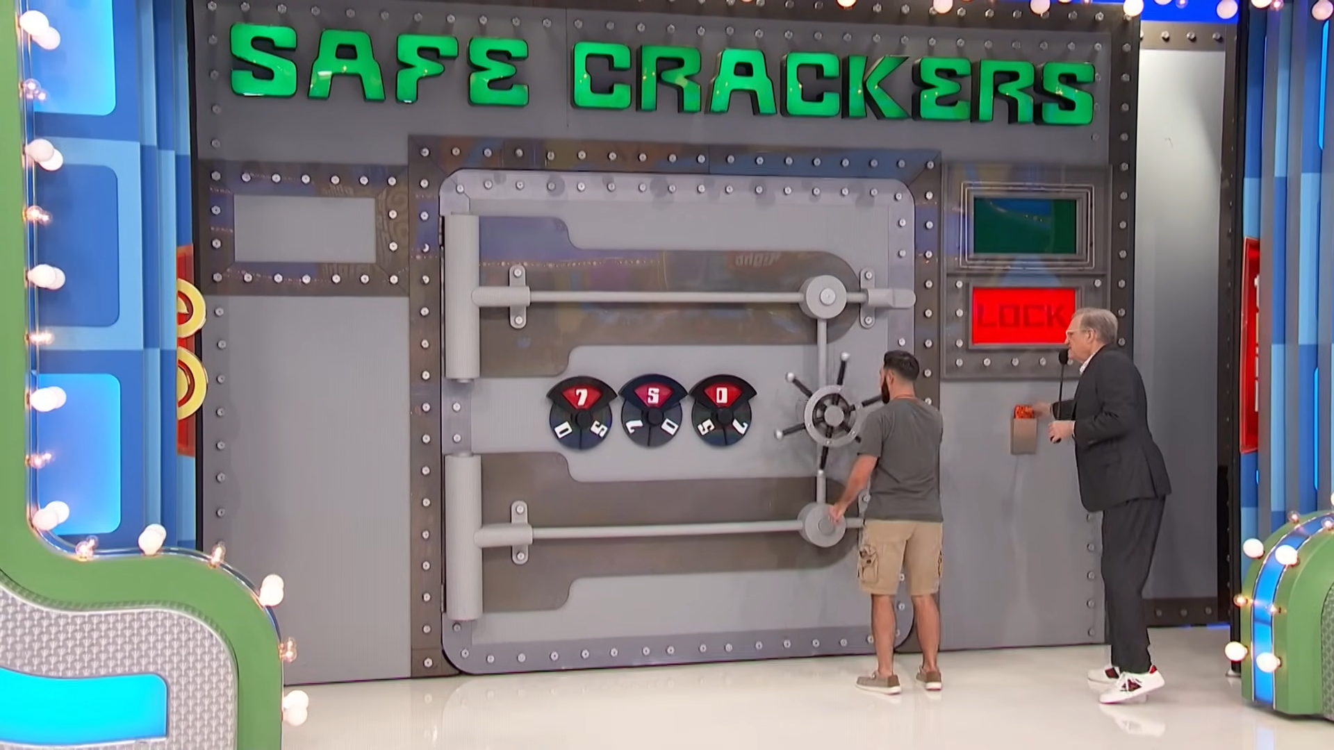 Contestant attempting to unlock the Safe Crackers game on The Price is Right, with numbers 7, 5, and 0 visible on the combination dial.