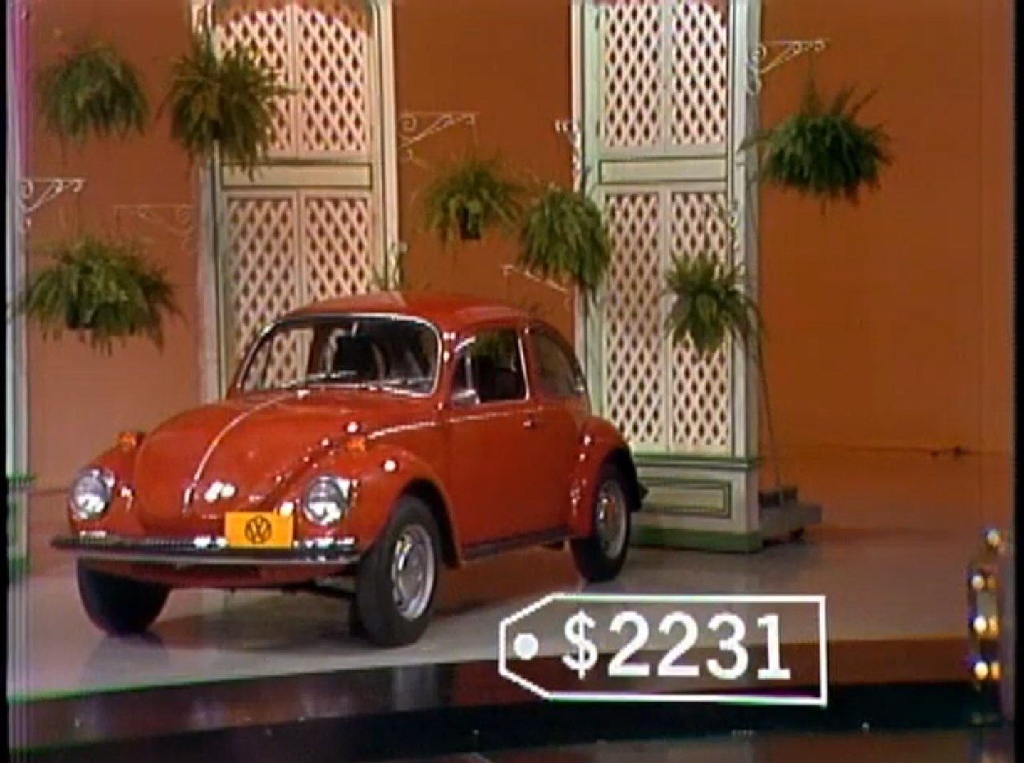A red 1972 Volkswagen Beetle displayed on a game show stage with a price tag of 31.