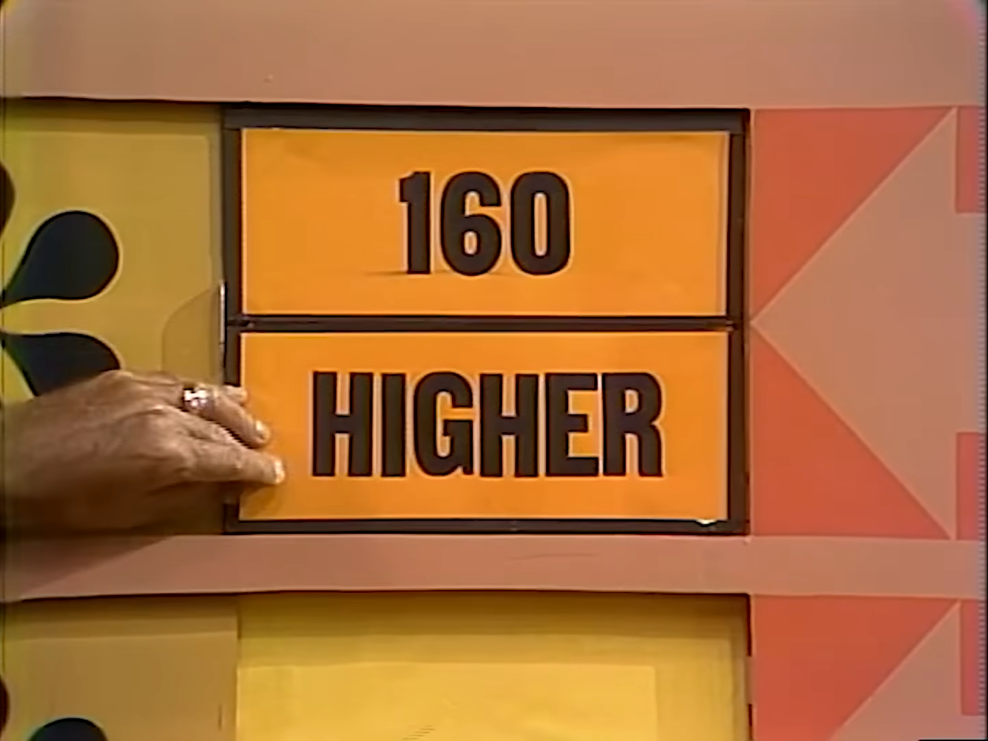 A hand is shown pointing to a game board displaying the numbers '160' and the word 'HIGHER' in large letters.