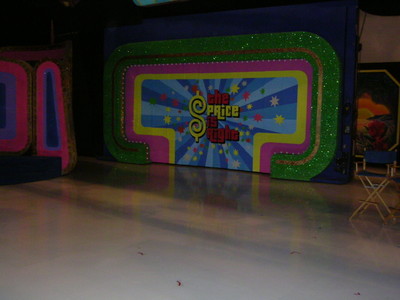 Colorful stage backdrop for 'The Price Is Right' featuring bright patterns and the show's title, set against a shiny floor.
