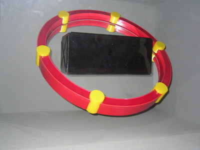 A red and yellow circular ring display with a black rectangular object in the center, showcased in a gray background.