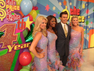 Cast members of 'The Price is Right' pose together in colorful outfits at the show's 34th anniversary celebration.
