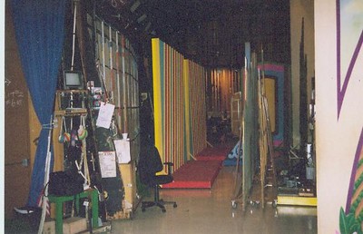 View of the Bob Barker Studio interior behind Door #1,, showing colorful backdrop walls, a red carpet runner, and various studio equipment.