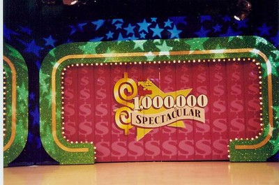 $1,000,000 Spectacular stage backdrop with green glitter edges and dollar symbol decorations.