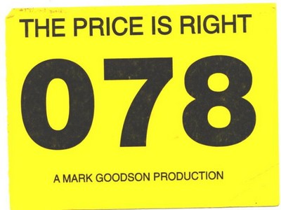 A yellow prop sign from 'The Price is Right' game show, featuring the text 'THE PRICE IS RIGHT 078' and 'A MARK GOODSON PRODUCTION' underneath.