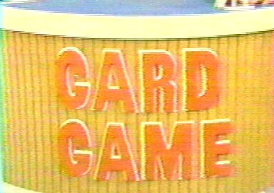 Close-up of a game board featuring the words 'CARD GAME' in large orange letters on a striped background.