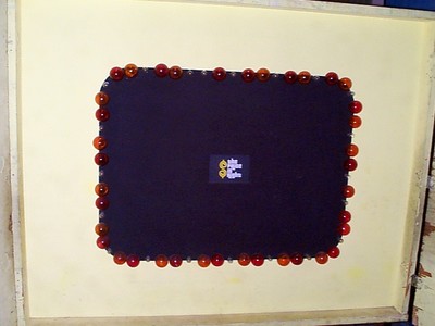 A game board featuring a rectangular outline adorned with red and orange circular props along the edges, with a central purple area displaying a logo.