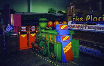 Colorful display featuring a train and game signage in a storage area.