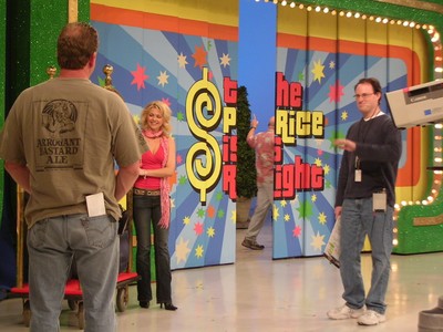 Behind the scenes at The Price Is Right set, showcasing hosts and crew preparing for a recording.