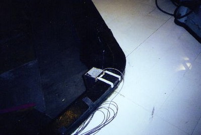 A close-up view of the corner of a stage at CBS Television City, featuring wires and equipment along the edge on a glossy floor.