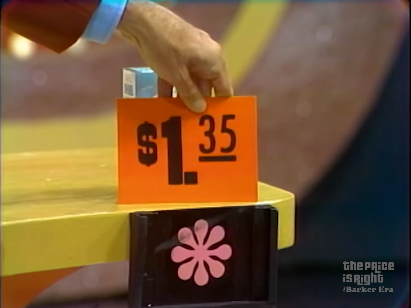 .35 price tag displayed in a game segment of The Price is Right, with a hand holding the tag.