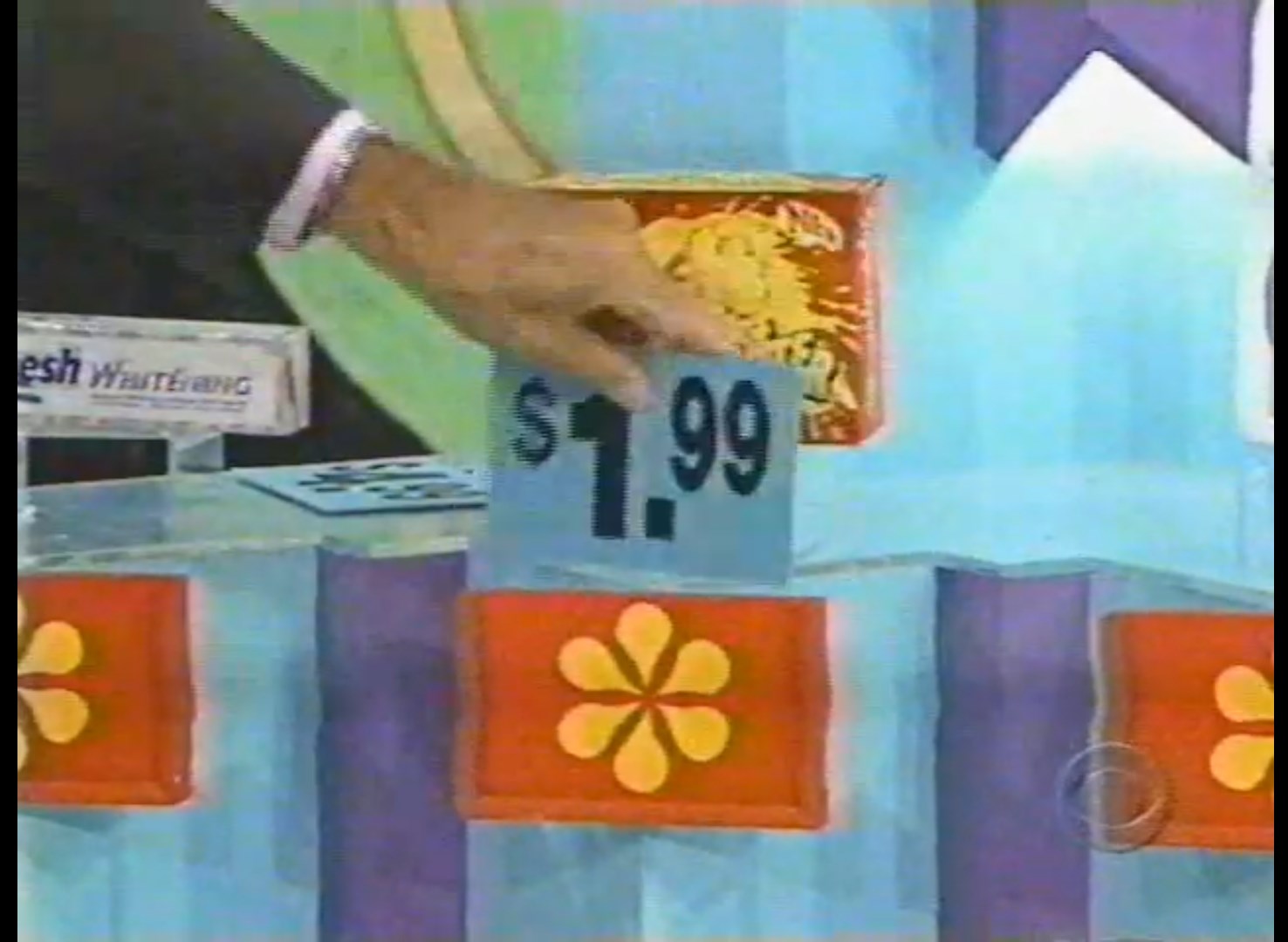 A contestant on The Price is Right places a price card reading .99 into one of the game slots during the Hi Lo pricing game.