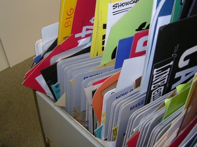 A close-up view of colorful game show props and signs organized in a container.