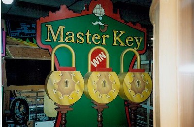 A colorful display of the 'Master Key' game from a TV show, featuring three large locks with a green backdrop and the word 'WIN' visible.