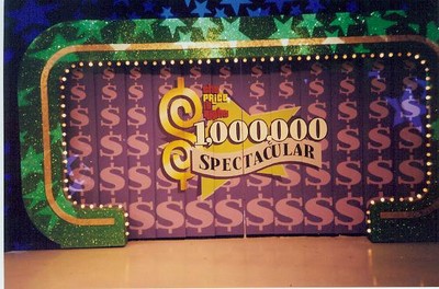 A colorful backdrop featuring the words '1,000,000 Spectacular' with a dollar sign design, used for a special event on The Price is Right.