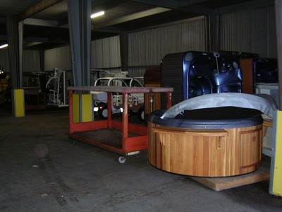 Wooden hot tub and red cart in studio warehouse