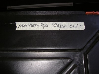 Close-up of a label reading 'Marker for Copper Cord' attached to a black surface.