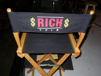 A director's chair with the words 'RICH' and 'TPIR' printed on the back in bold lettering.
