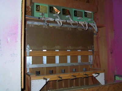 Interior view of the Temptation game board setup featuring multiple audio equipment, set against a pink background.