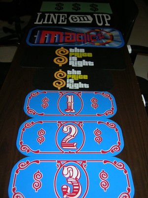 A collection of colorful game show props including signs and price markers from 'The Price Is Right.'
