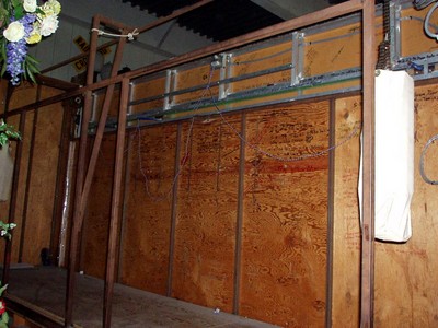 Interior view of the Ten Chances set with wooden walls and a metal structure, showcasing equipment and wiring.