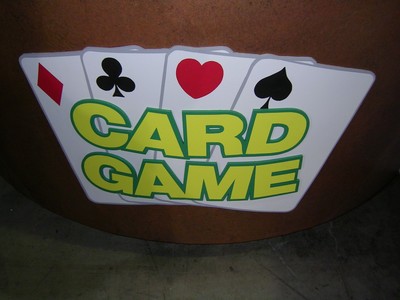 A sign displaying the words 'CARD GAME' with playing card symbols, including a diamond, heart, spade, and club.