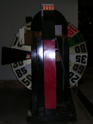A view of a large spinning wheel with numbered sections, used as a prop in game shows.
